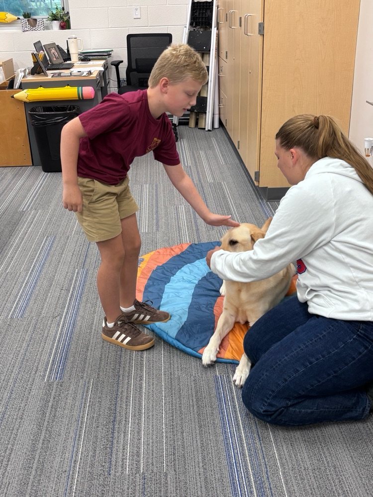 student petting dog