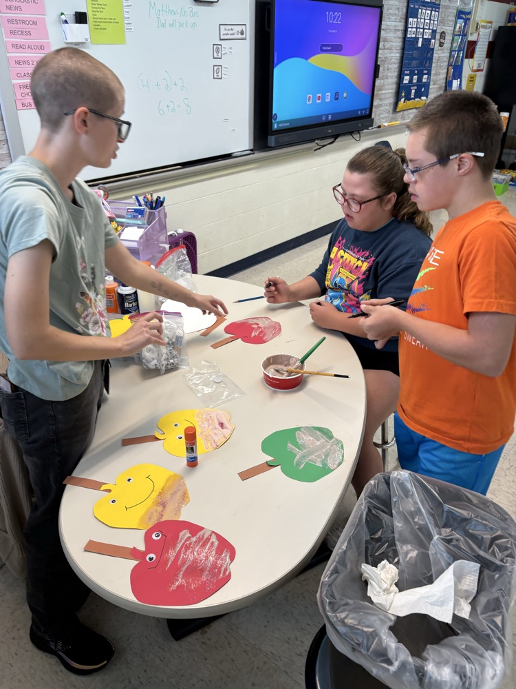 students painting apples