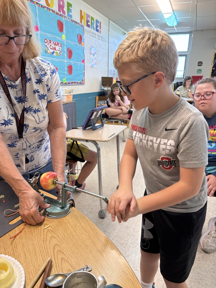 student peeling apple