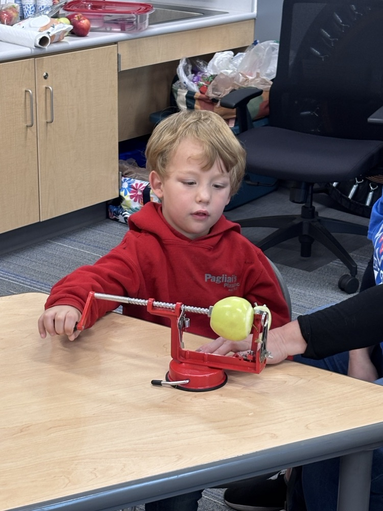 student peeling apple