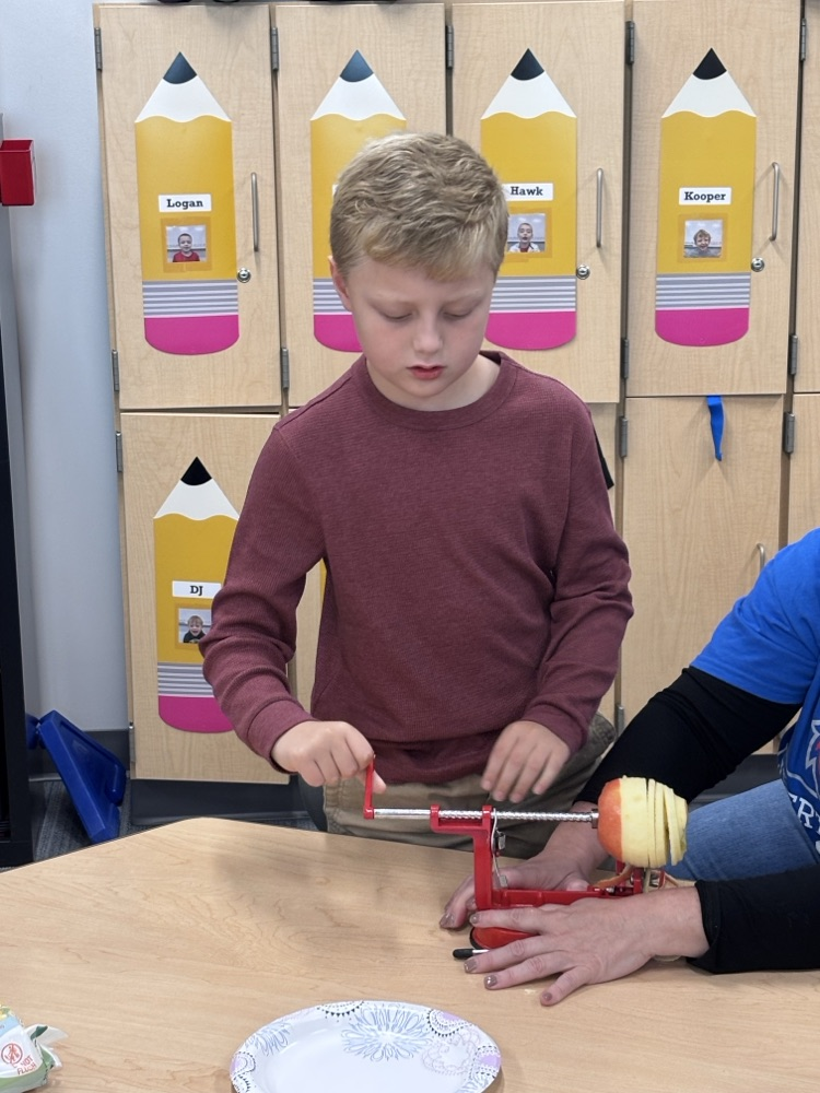 student peeling apple