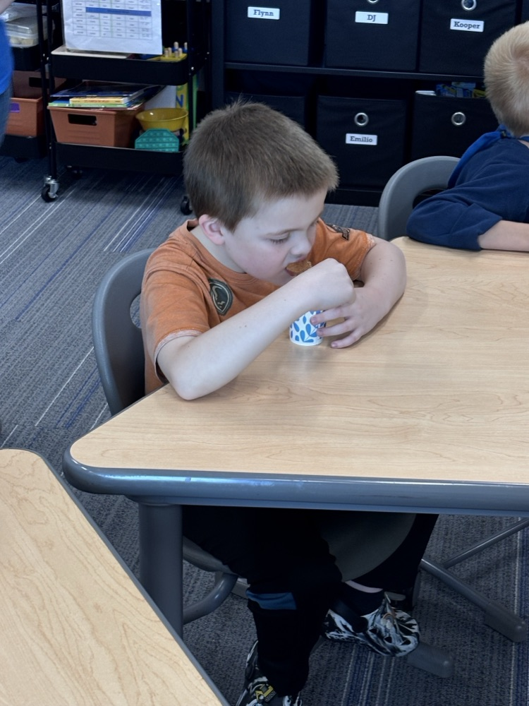 student eating applesauce