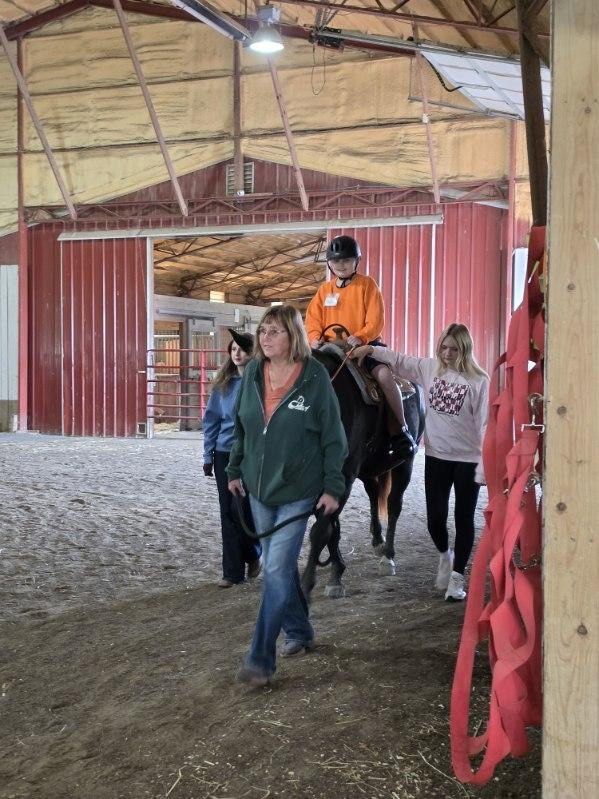 student riding horse