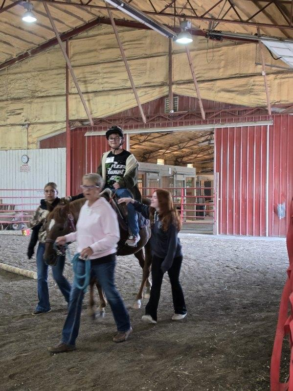 student riding horse