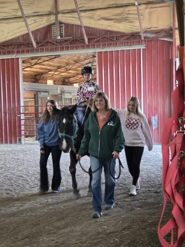 student riding horse