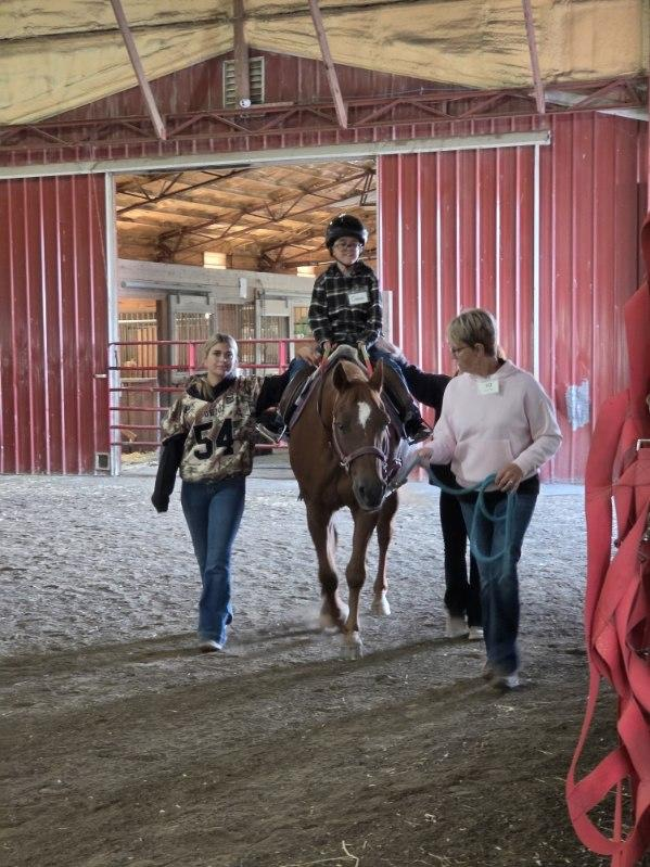 student riding horse 