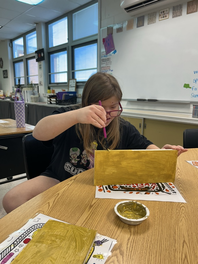student painting wood