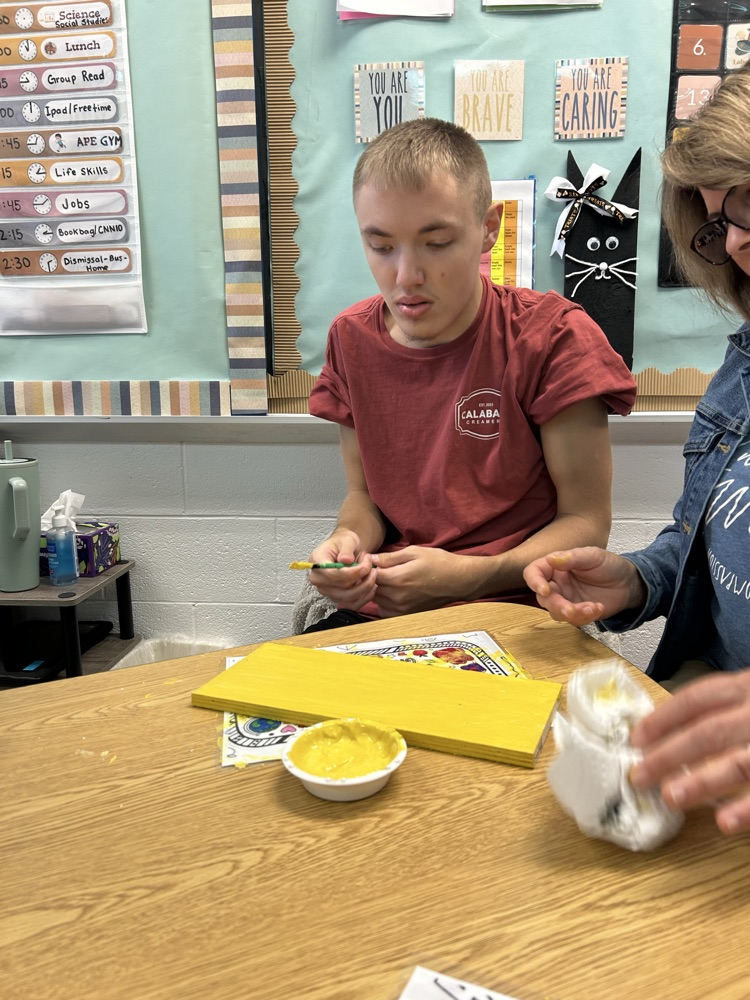 student painting wood