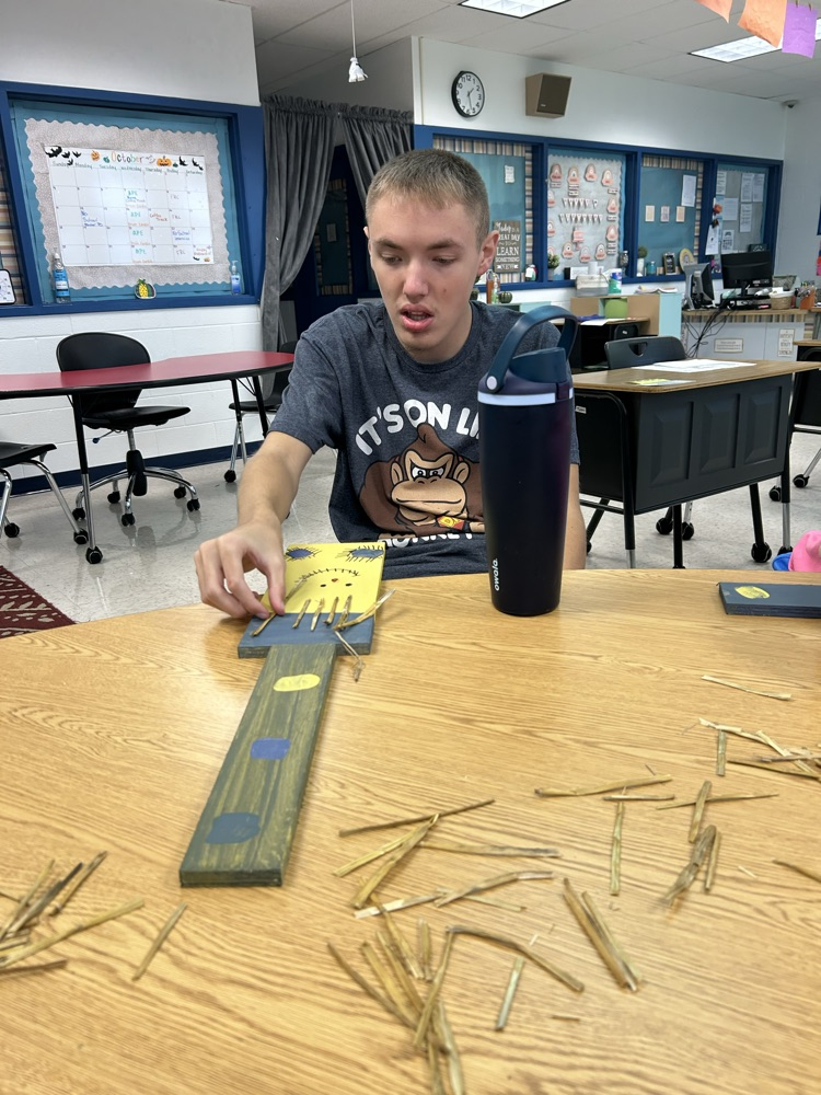 student decorating wood