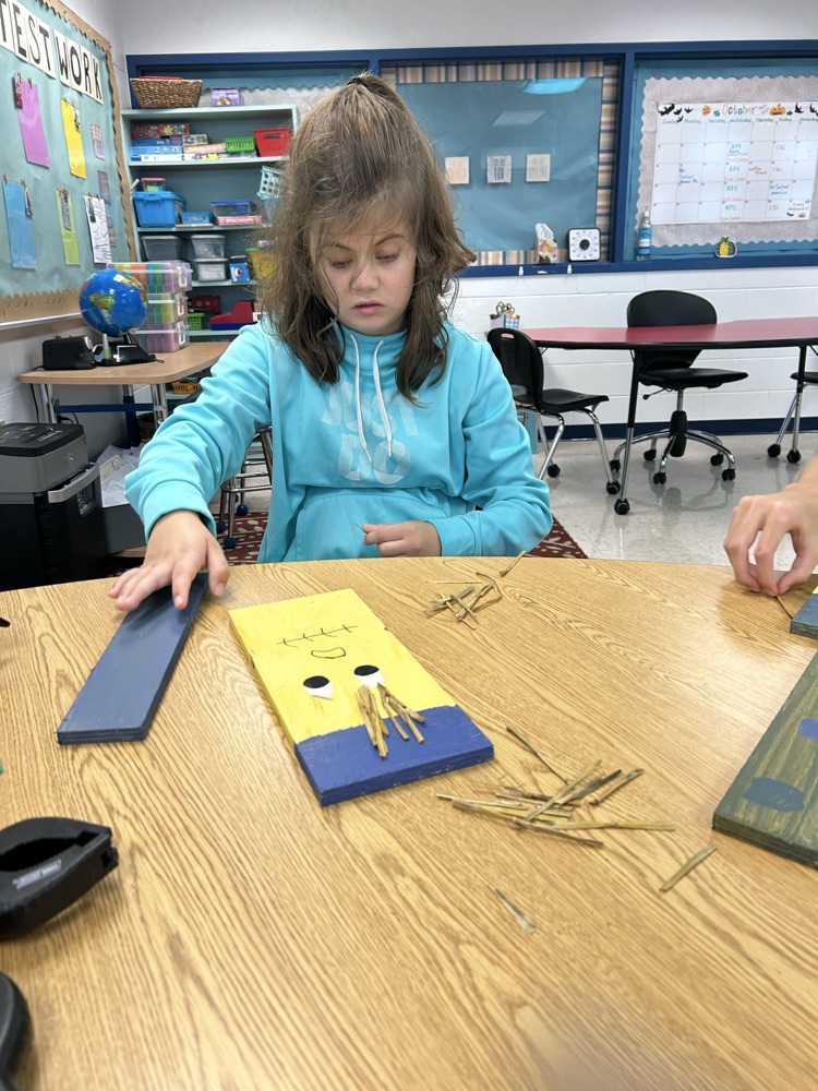 student decorating wood