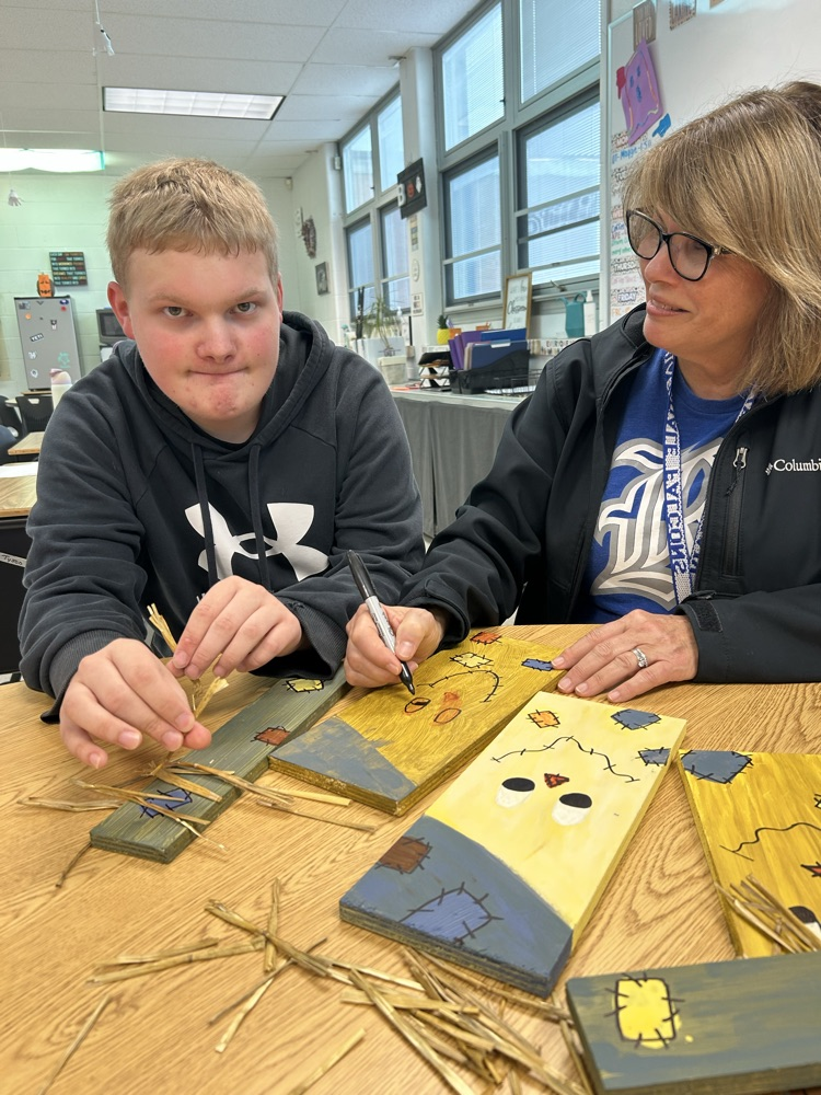 student decorating wood