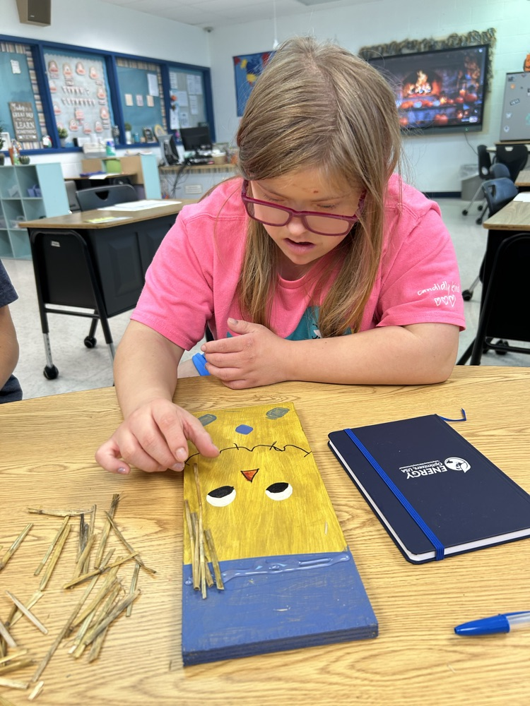 student decorating wood