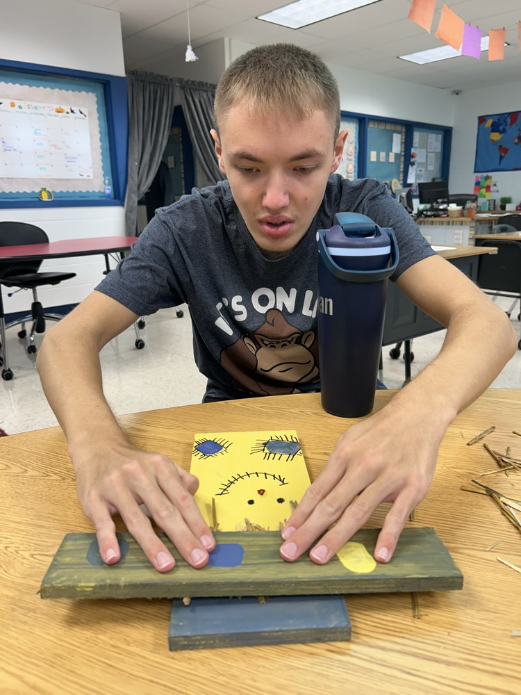 student decorating wood