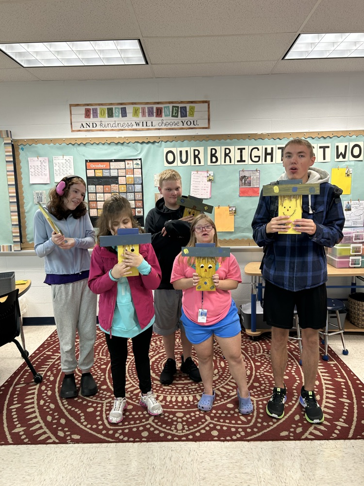 students with completed scarecrows