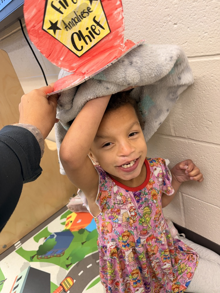 girl with firefighter hat on