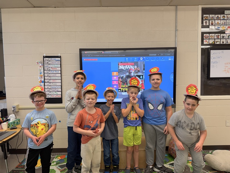 class with firefighter hats on
