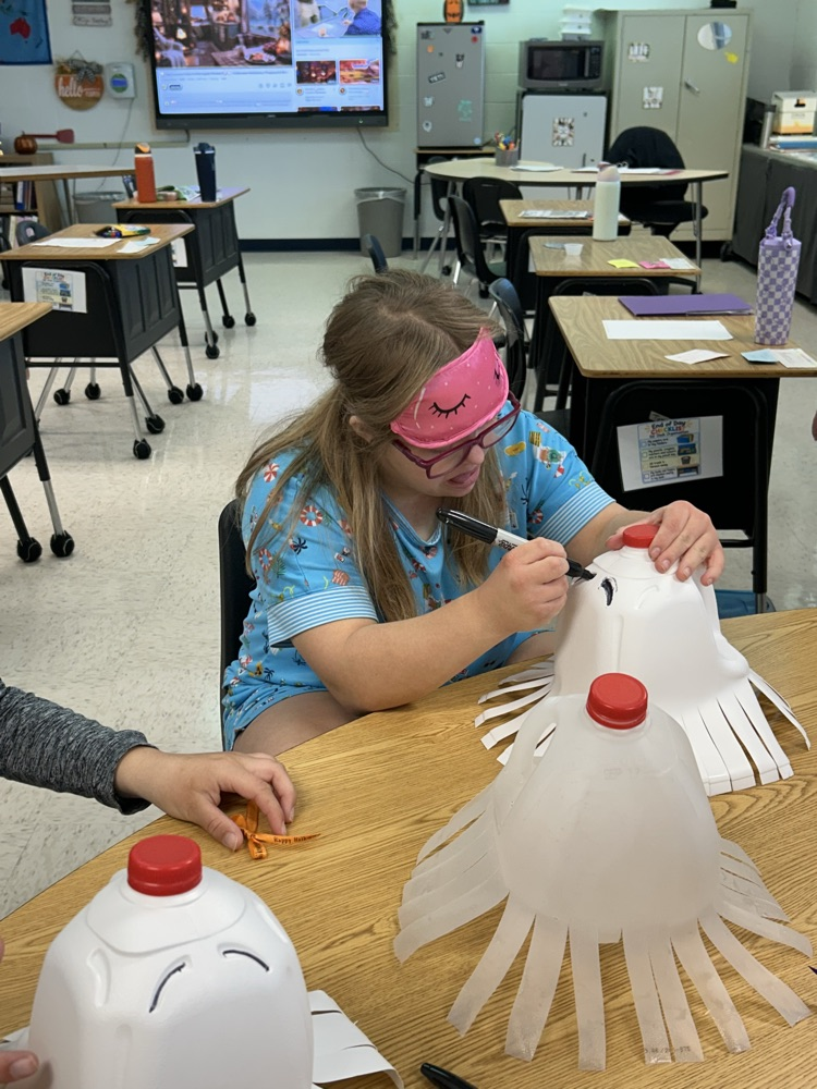 student drawing ghost faces