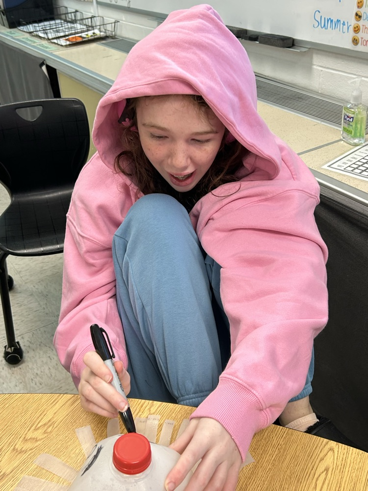 student drawing ghost faces