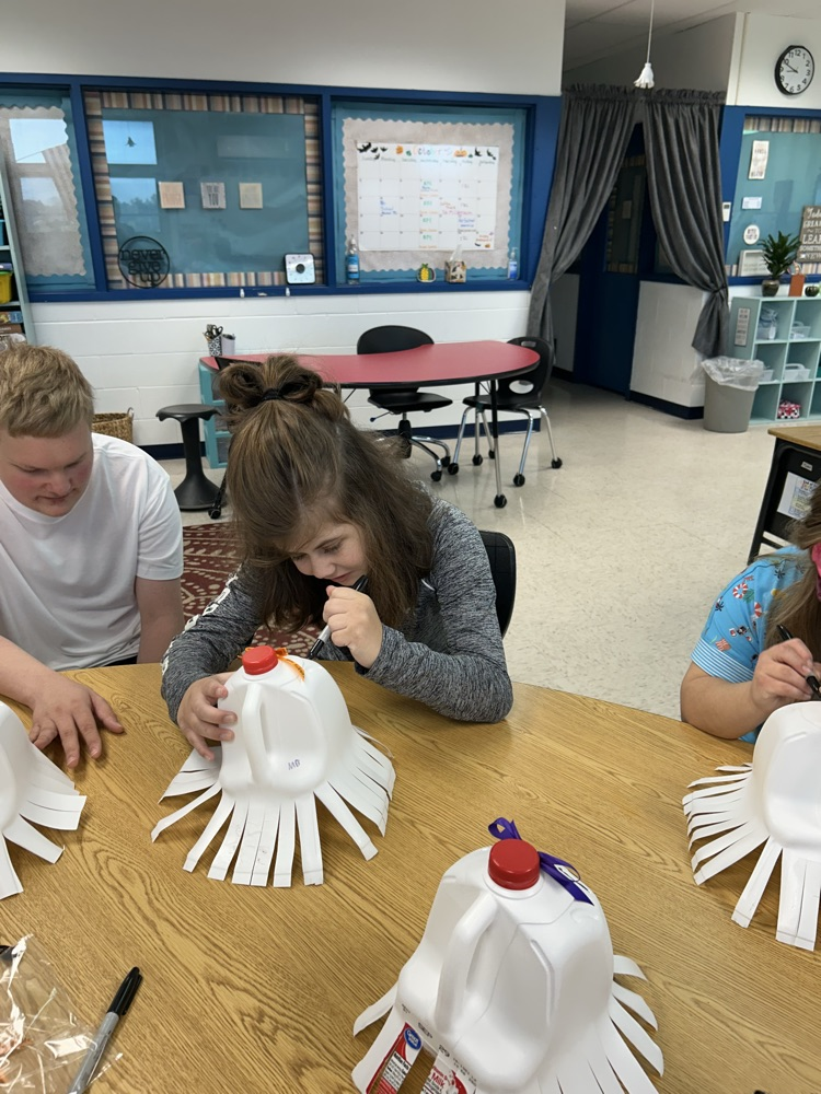 student drawing ghost faces