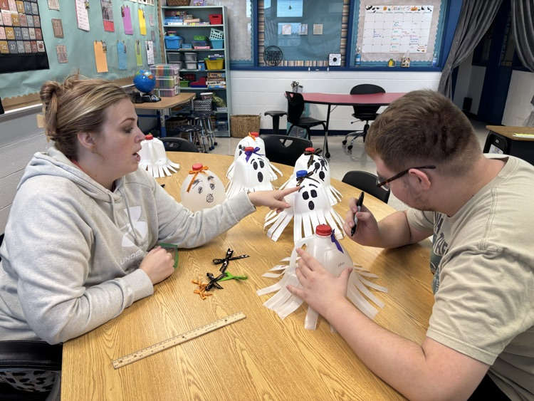 student drawing ghost faces