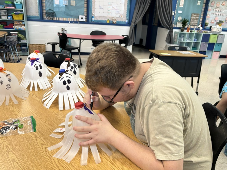 student drawing ghost faces