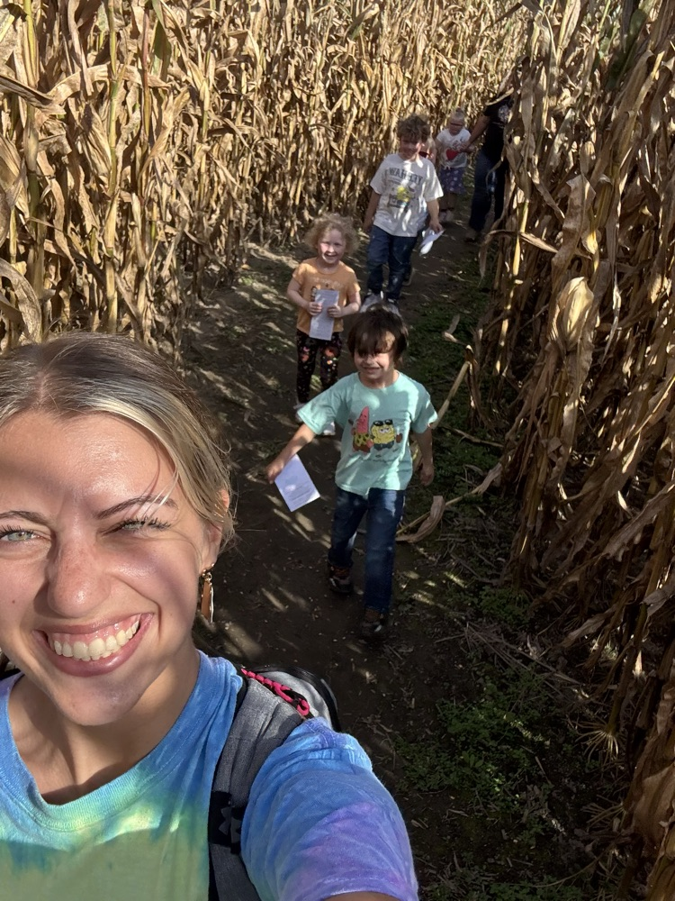 students walking through corn maze