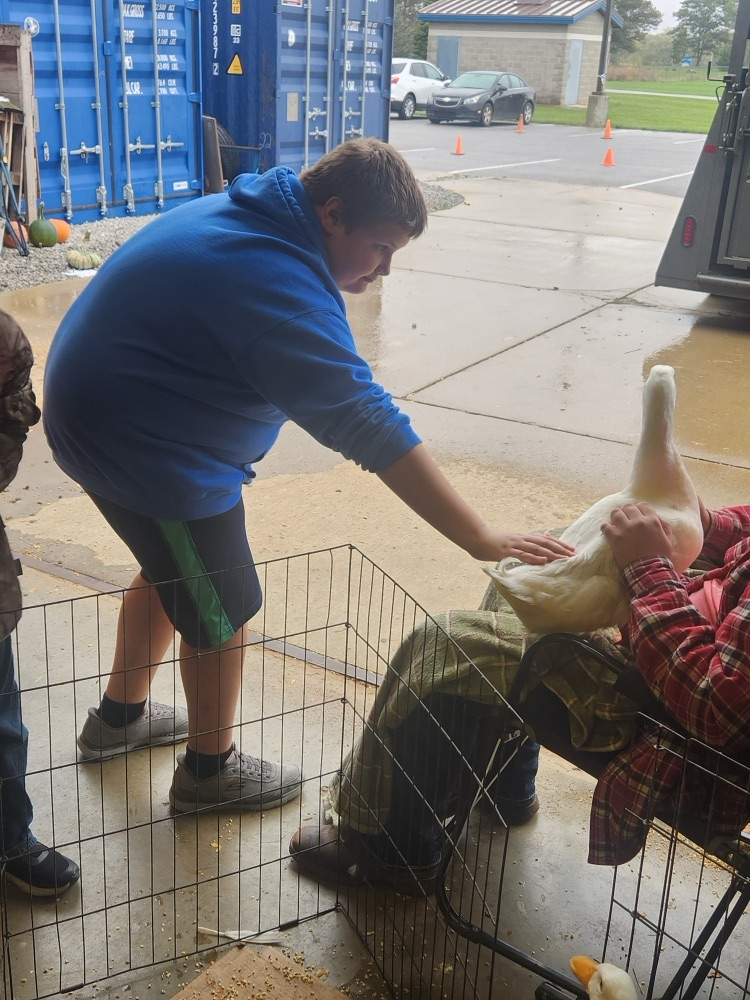 student petting duck