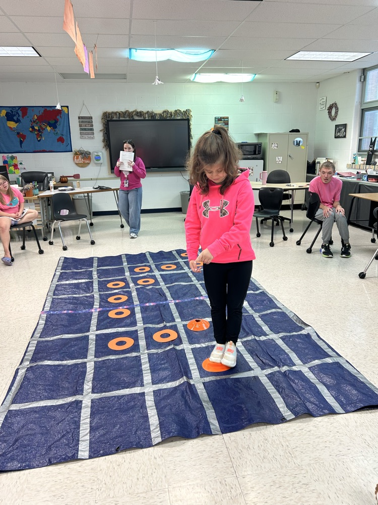 student standing on tarp