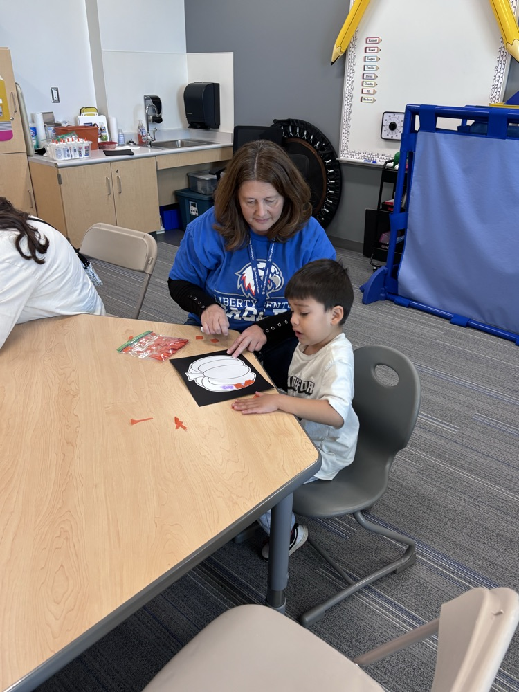 student doing a craft with grandparent