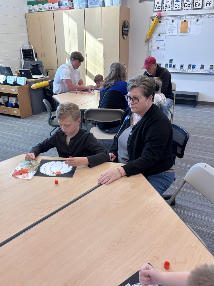 student doing a craft with grandparent