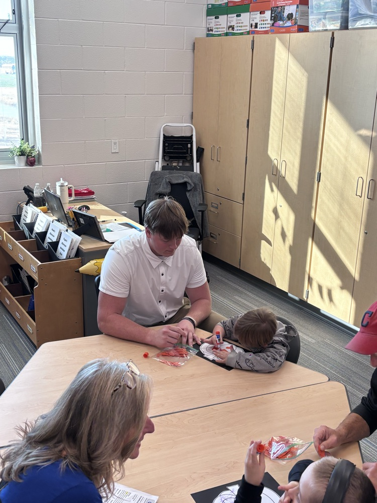 student doing a craft with grandparent