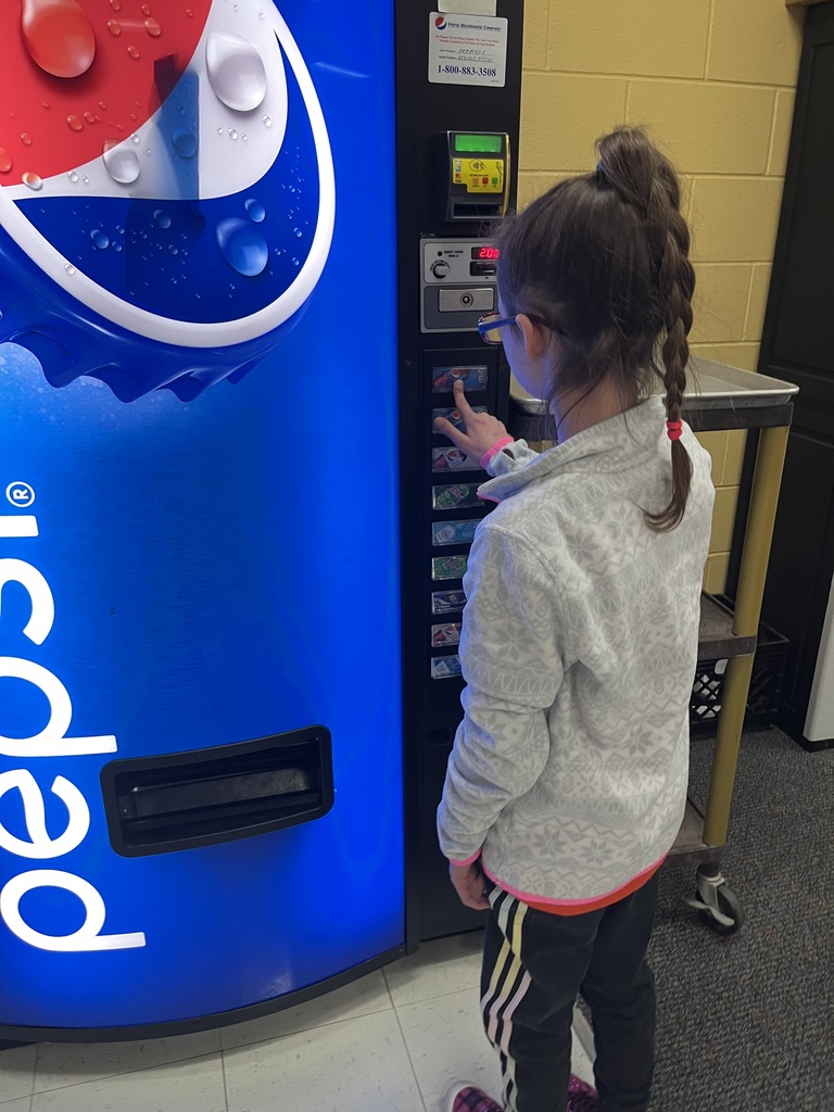 student choosing pop from vending machine