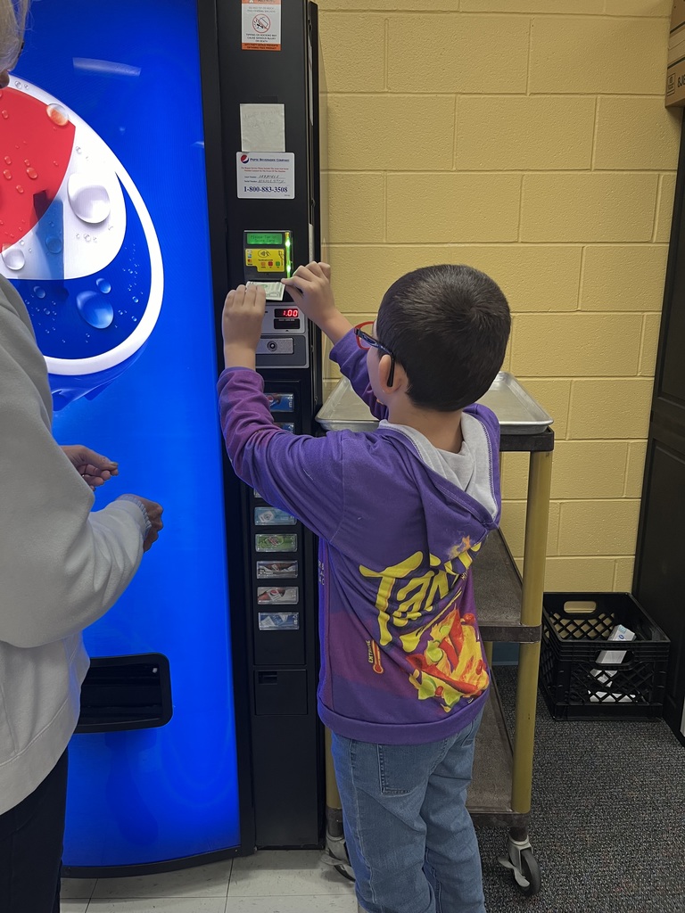 student putting money into vending machine