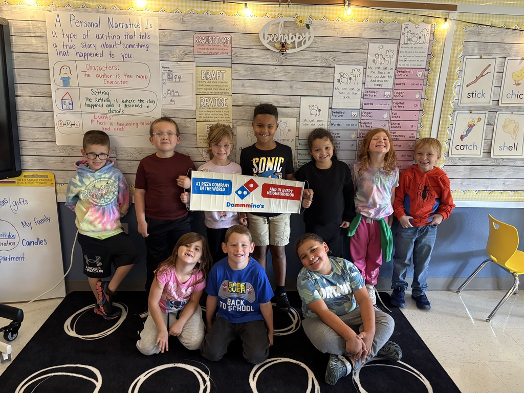 A class holding a Domino's banner.