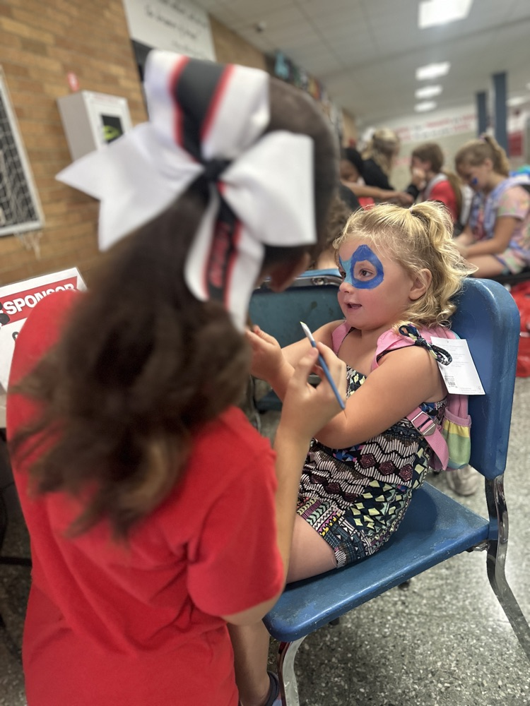 cheer leaders painting faces