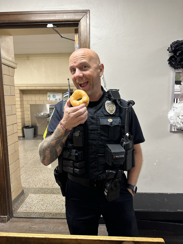 officer eating a donut