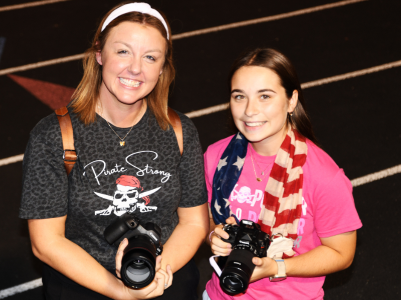 two women holding cameras