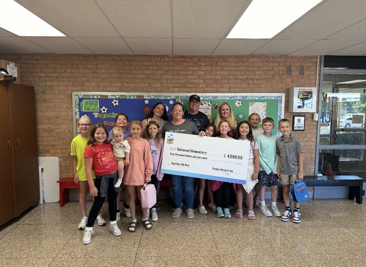 students holding big check