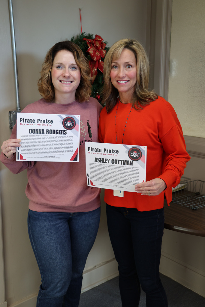 food service staff holding a recognition certificate 
