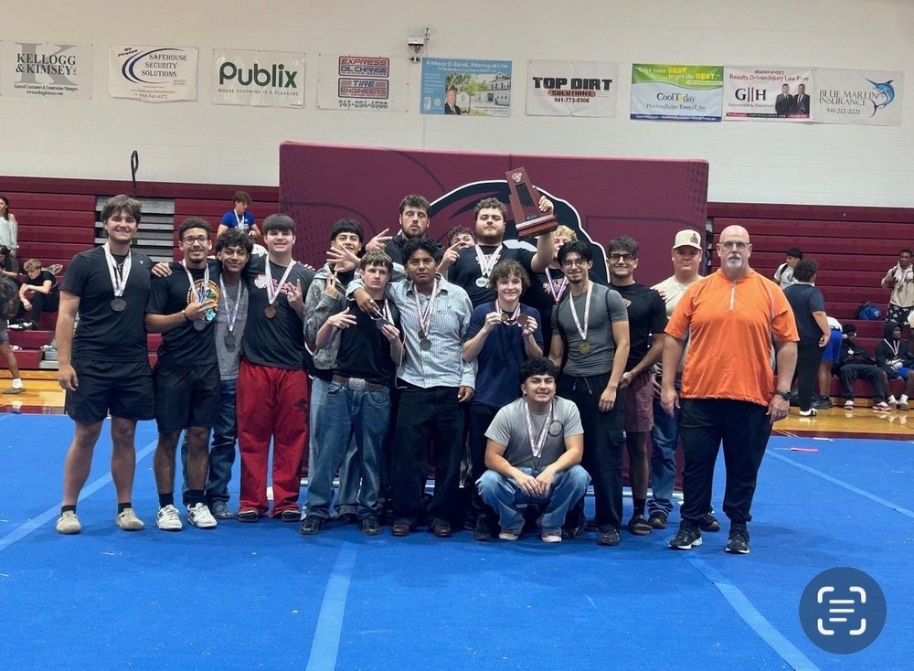 the HHS weightlifting team holds up their awards