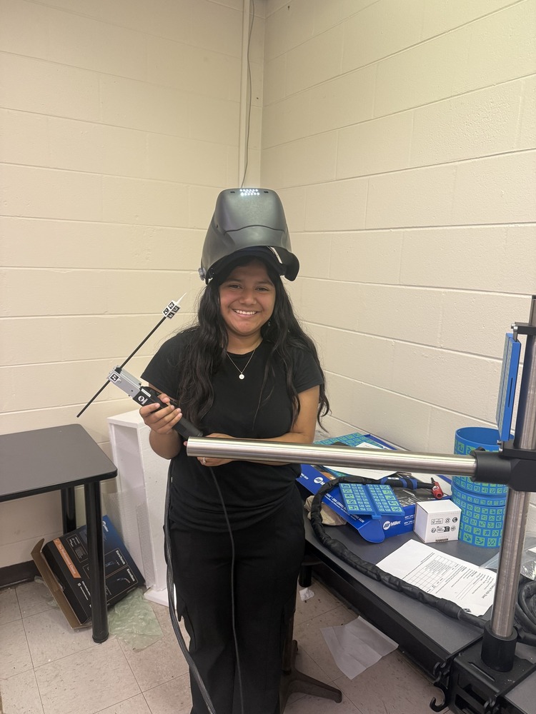 Neida Rodriguez with a welding mask on