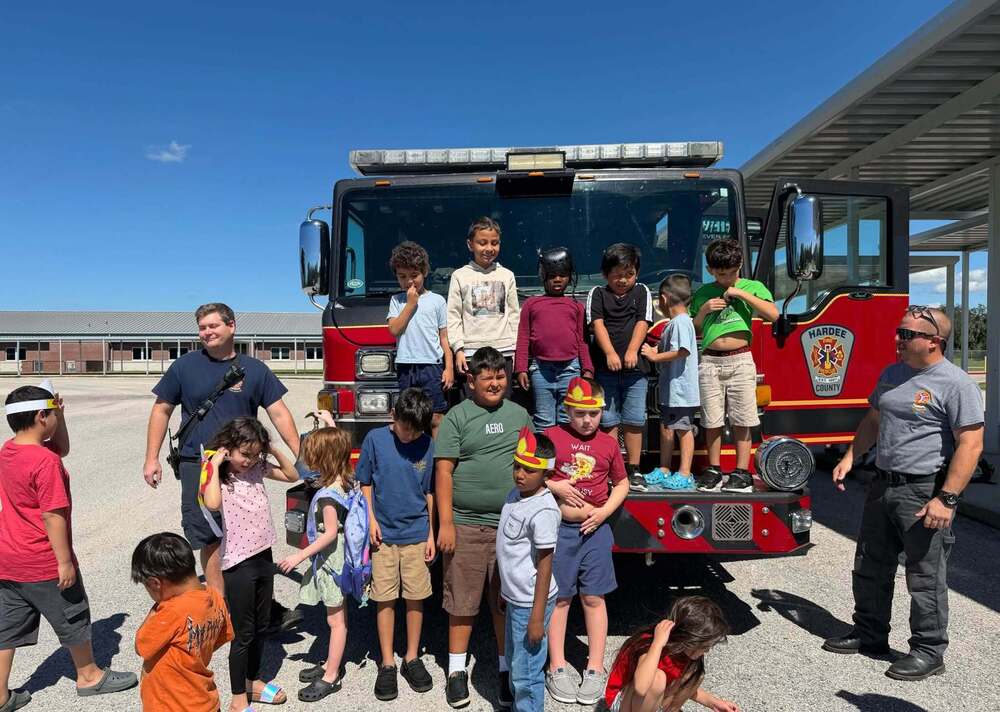 a group of students in front of a fire truck