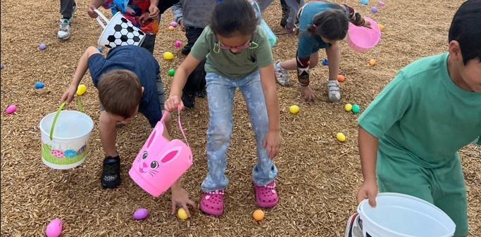 students picking up Easter Eggs