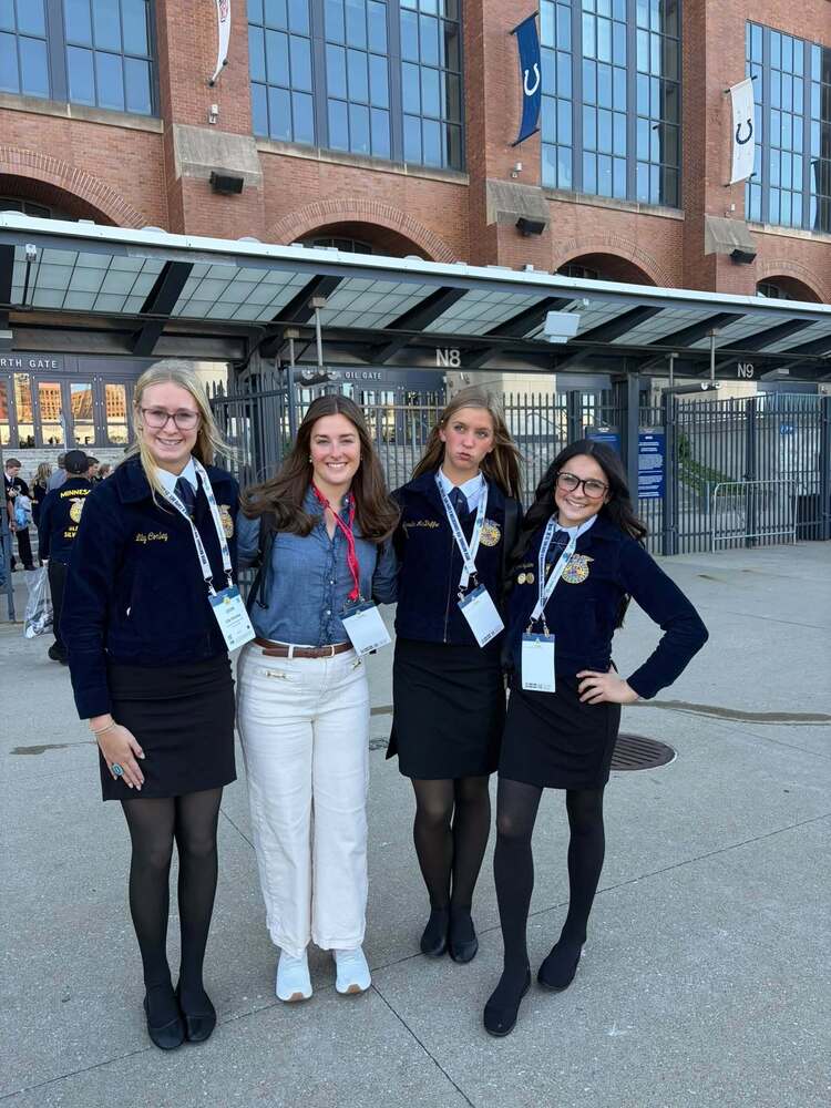 four women posing together