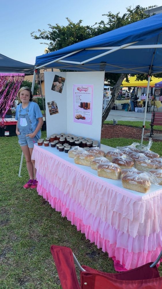 girl with her baked goods and jams table  setup