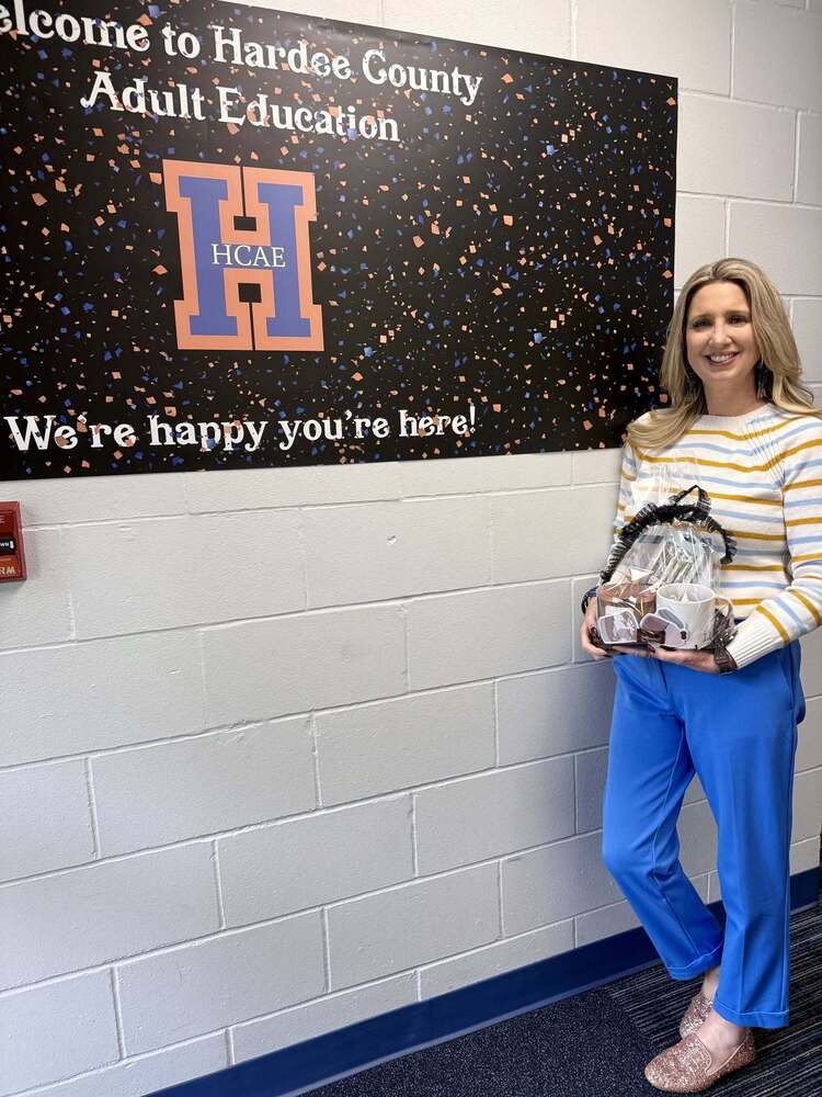 a woman next to bulletin board