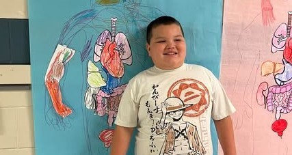 boy with his life-size human body replica with paper colored parts glued on paper