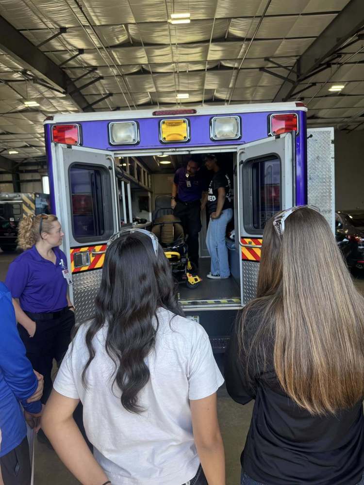 students look inside an ambulance