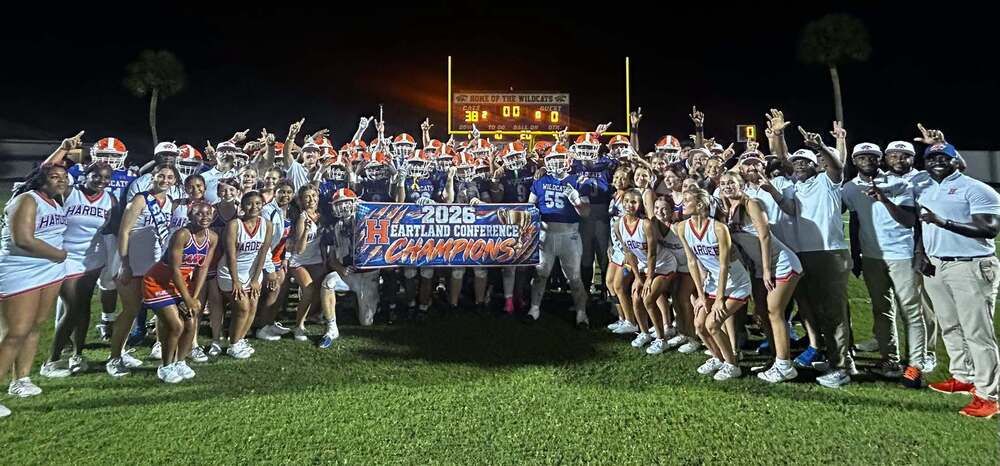 football and cheerleading teams celebrating a win