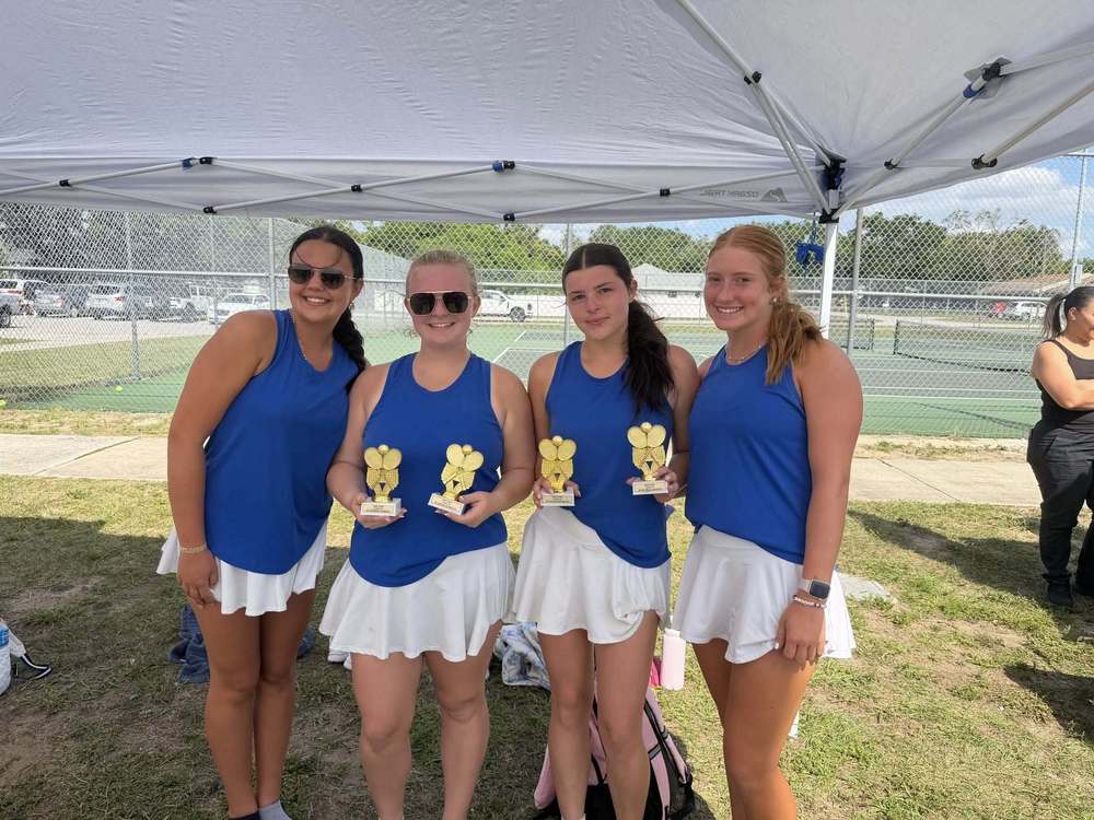 tennis players with their trophies